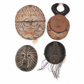 Appraisal: Four Circular Form West African Masks the first carved with