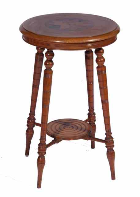 Appraisal: A PALE MAHOGANY CIRCULAR OCCASIONAL TABLE with inlaid specimen wood