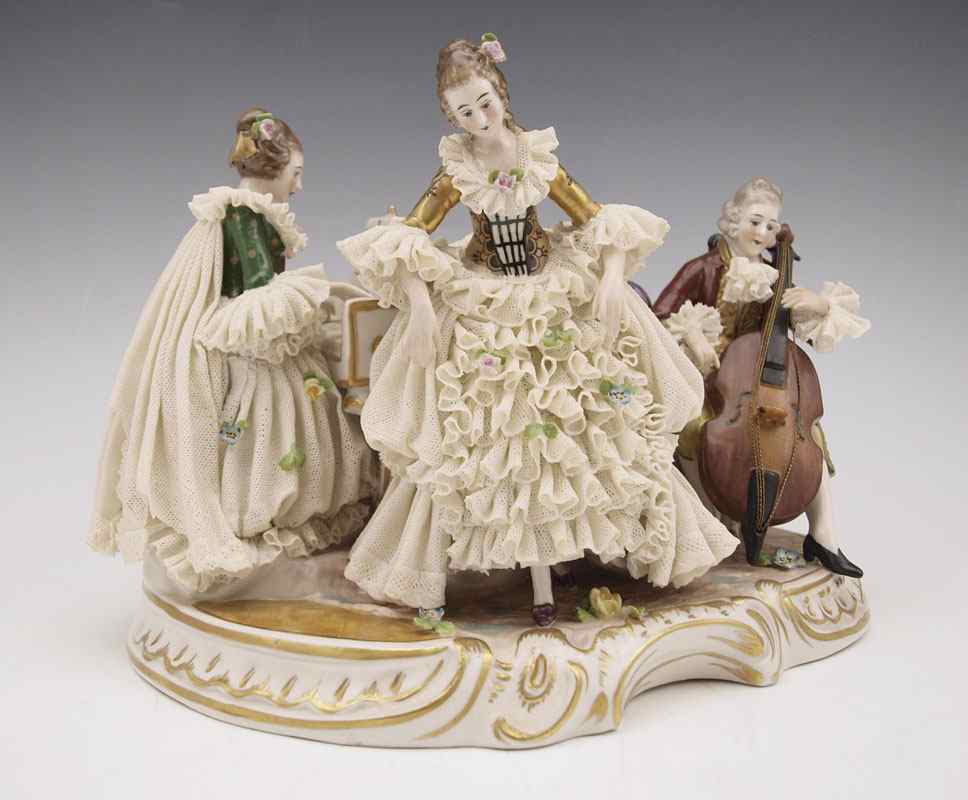 Appraisal: FURSTENBURG LACY FIGURAL MUSIC GROUP WITH PIANO Approx '' tall