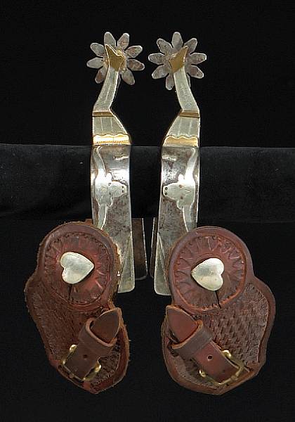 Appraisal: A pair of silver and brass-mounted gal leg spurs signed