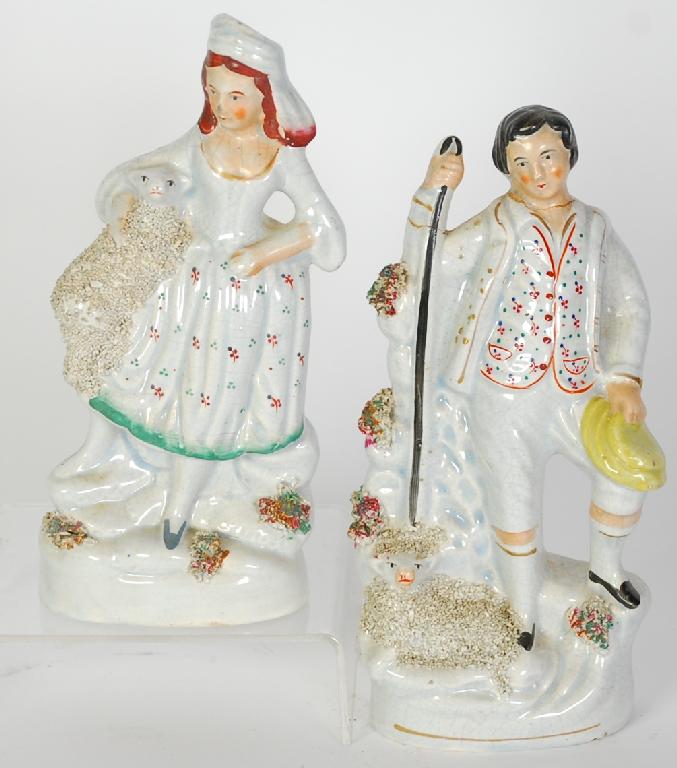 Appraisal: PAIR OF STAFFORDSHIRE POTTERY FIGURES of a shepherd and shepherdess