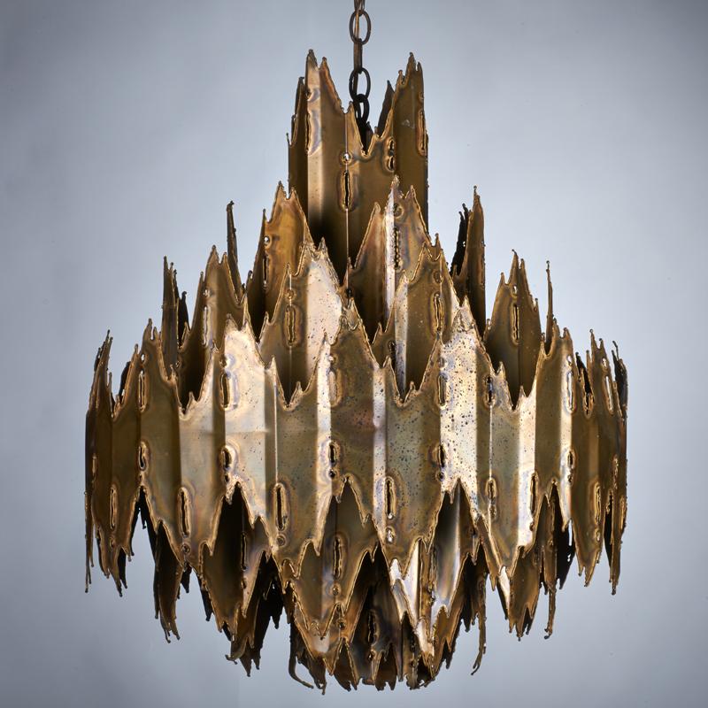 Appraisal: TOM GREEN Brutalist seven-light chandelier s Hand-torched patinated brass Unmarked