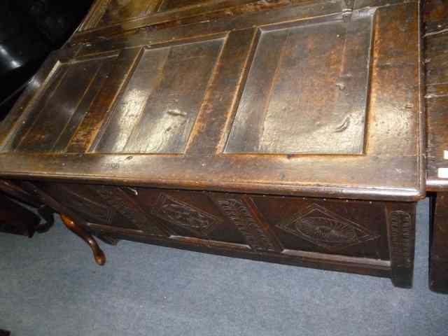 Appraisal: AN ANTIQUE OAK COFFER with triple panelled chip carved front