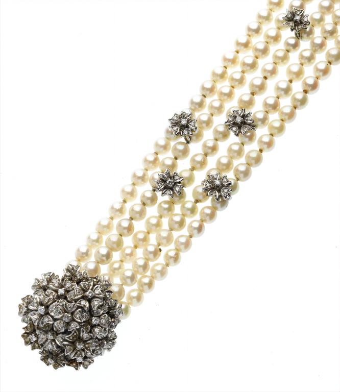 Appraisal: A CULTURED PEARL AND DIAMOND FIVE-ROW BRACELET with flowerheads of