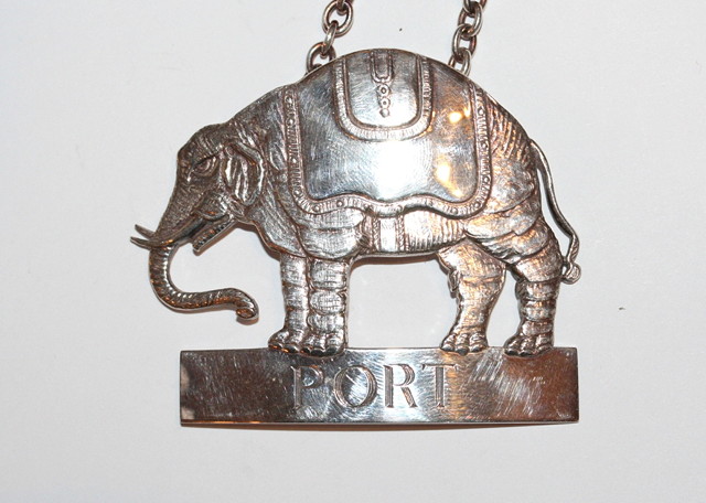 Appraisal: A CONTEMPORARY SILVER DECANTER LABEL pierced in the form of