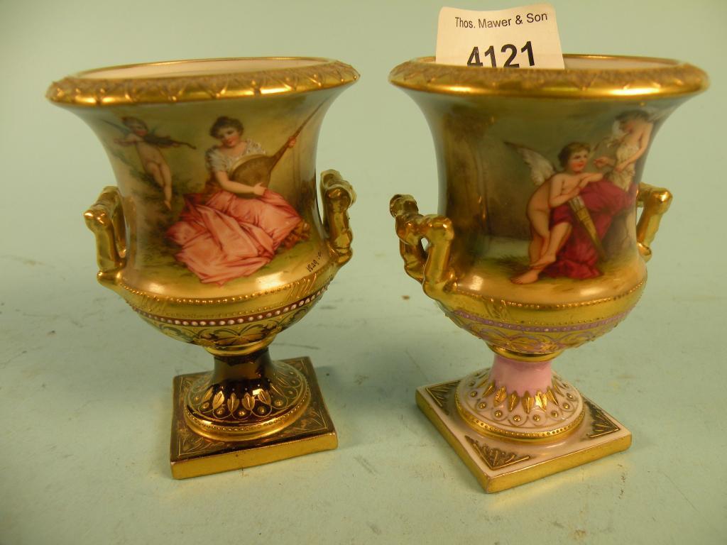 Appraisal: A pair of Vienna porcelain urns each decorated with a