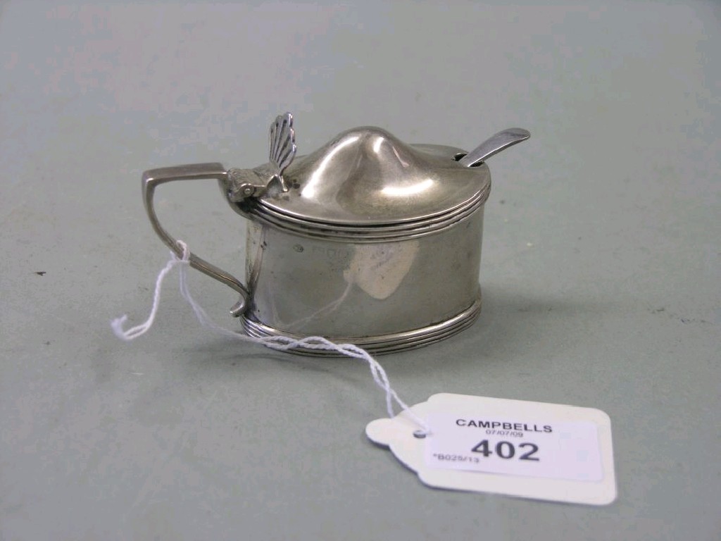 Appraisal: A silver mustard pot with hinged cover complete with blue