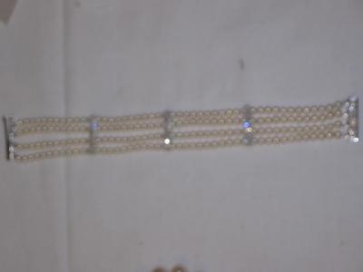 Appraisal: A PEARL AND DIAMOND BRACELET comprising four rows of single