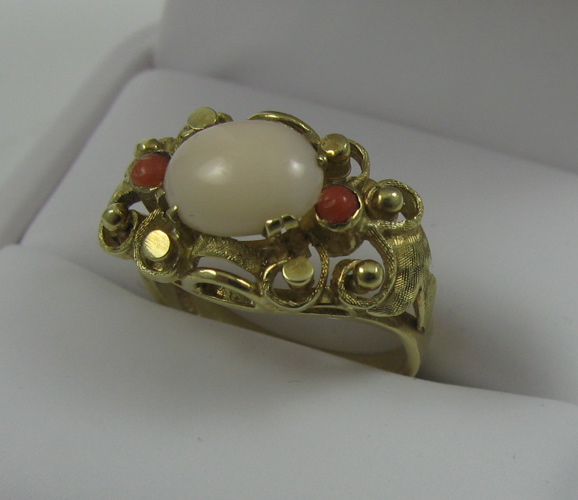 Appraisal: PINK CORAL AND FOURTEEN KARAT GOLD RING set with three