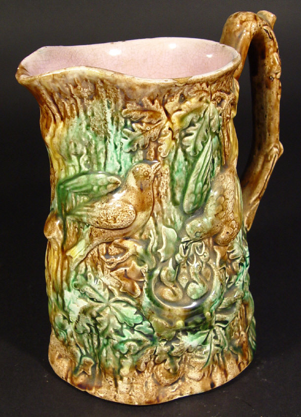 Appraisal: Victorian Majolica log shaped jug relief moulded with birds under