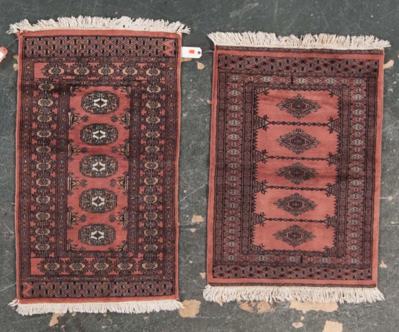 Appraisal: Two Pakistani Bohkara rugs Pakistan modern One rug is x