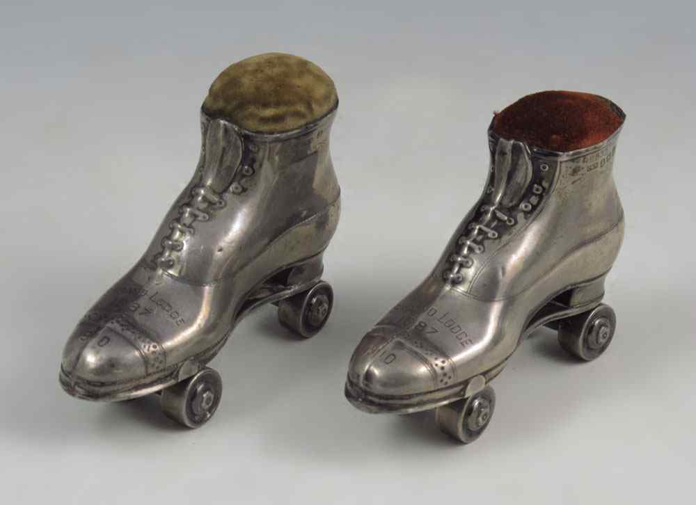 Appraisal: WHIMSICAL EDWARDIAN SILVER ROLLER SKATE FIGURAL PIN CUSHIONS Bear the