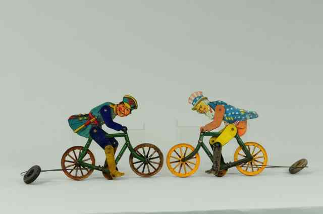 Appraisal: UNCLE SAM AND POLICEMAN ON BICYCLE STRING TOYS Lithographed tin