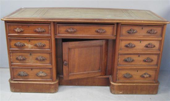 Appraisal: th mahogany knee hole desk nine drawers and cupboard on