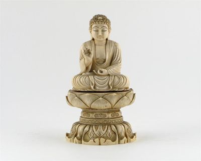 Appraisal: A Japanese ivory carving of Buddha wearing flowing robes seated