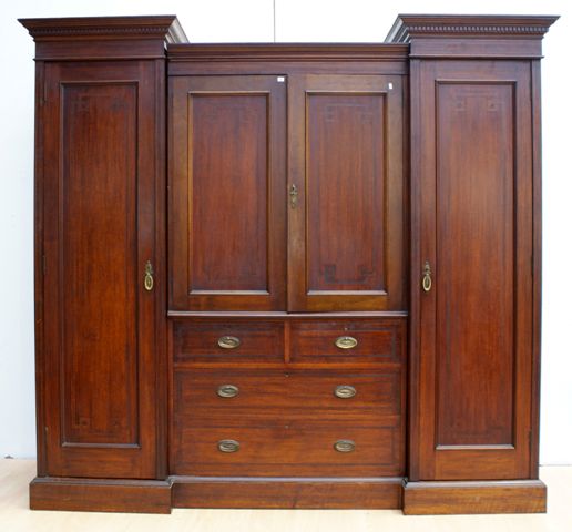 Appraisal: An Edwardian satinwood inlaid mahogany breakfront wardrobe with linen press