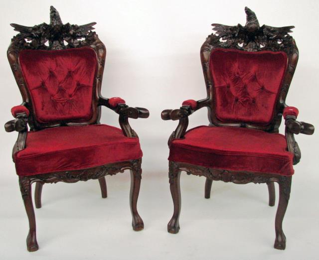 Appraisal: A pair of carved mahogany eagle arm chairs with button