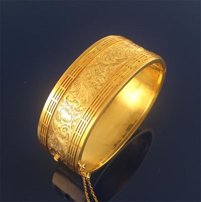 Appraisal: A th century gold hinged bangle chased with foliate scroll