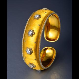 Appraisal: A Gold and Diamond Snowflake Bangle by Buccellati Designed as