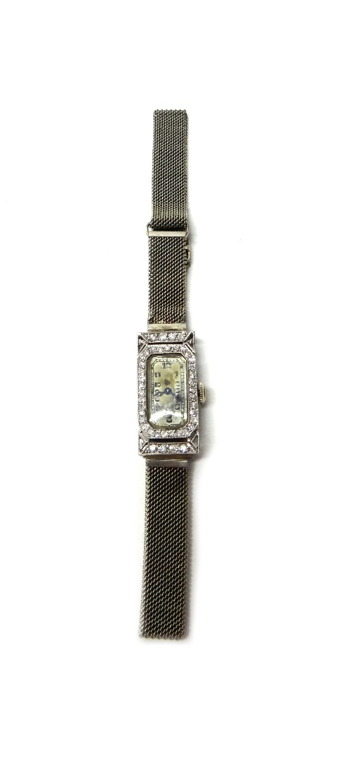 Appraisal: A lady's platinum rectangular cased and diamond set Jules Jurgensen