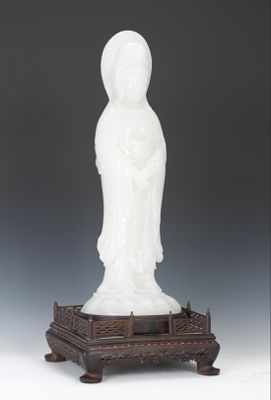 Appraisal: A Carved White Jade Quan Yin with Carved Wood Stand