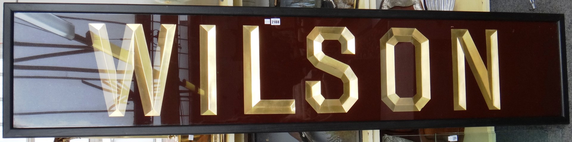 Appraisal: An Edwardian shop sign 'Wilson' gilt lettered against a brown