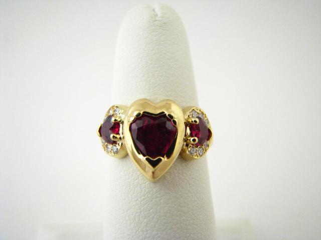 Appraisal: K Yellow Gold ring with three heart shaped rubies and