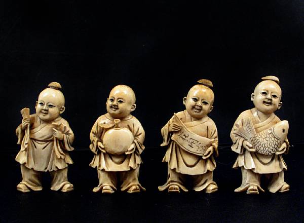 Appraisal: A group of four carved ivory Chinese boys together with