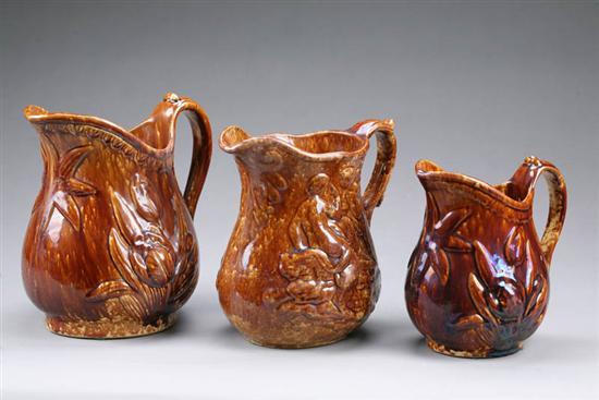 Appraisal: THREE ROCKINGHAM PITCHERS Two with tulip pattern h and h