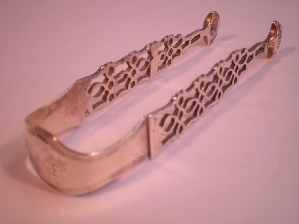 Appraisal: A pair of early thC silver sugar tongs of pierced