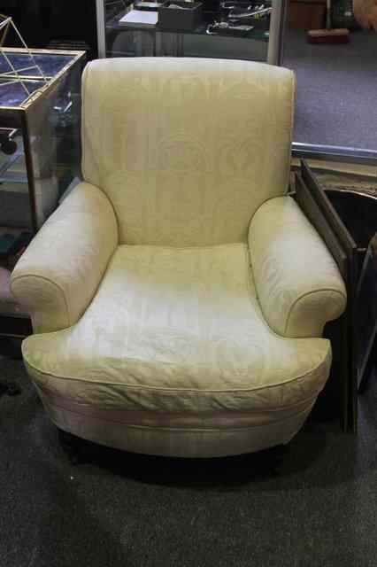 Appraisal: A VICTORIAN ARMCHAIR with shaped arms and stylised pale upholstery