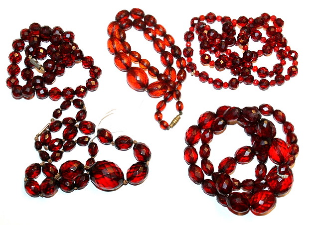 Appraisal: A COLLECTION OF FOUR GRADUATED RED AMBER FACETTED BEAD NECKLACES