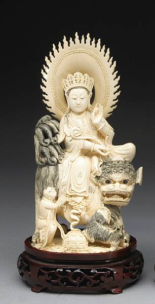 Appraisal: A tinted ivory figure of a Buddhist deity atop a