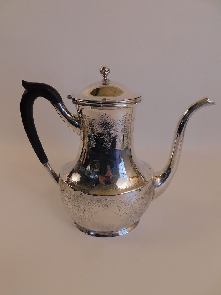 Appraisal: ANTIQUE STERLING SILVER TEAPOT Antique sterling silver teapot with ebony