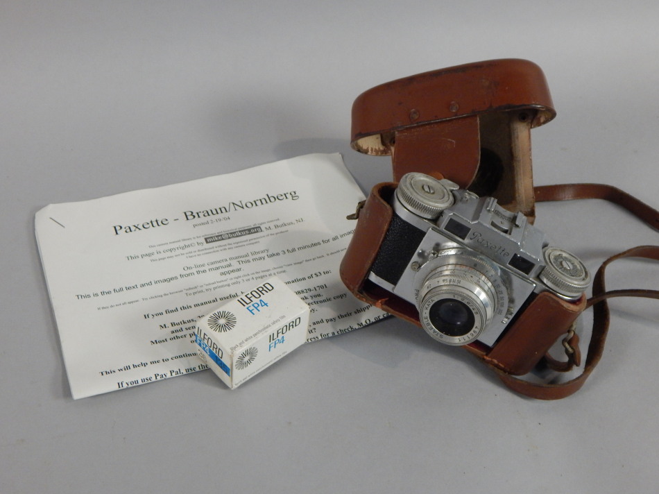 Appraisal: A Paxette chrome and pressed leather camera with Pronto-SVS and