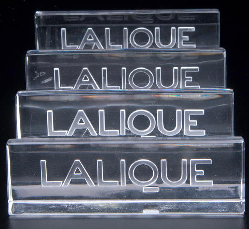 Appraisal: LALIQUE Four Lalique trade signs clear and frosted glass 's