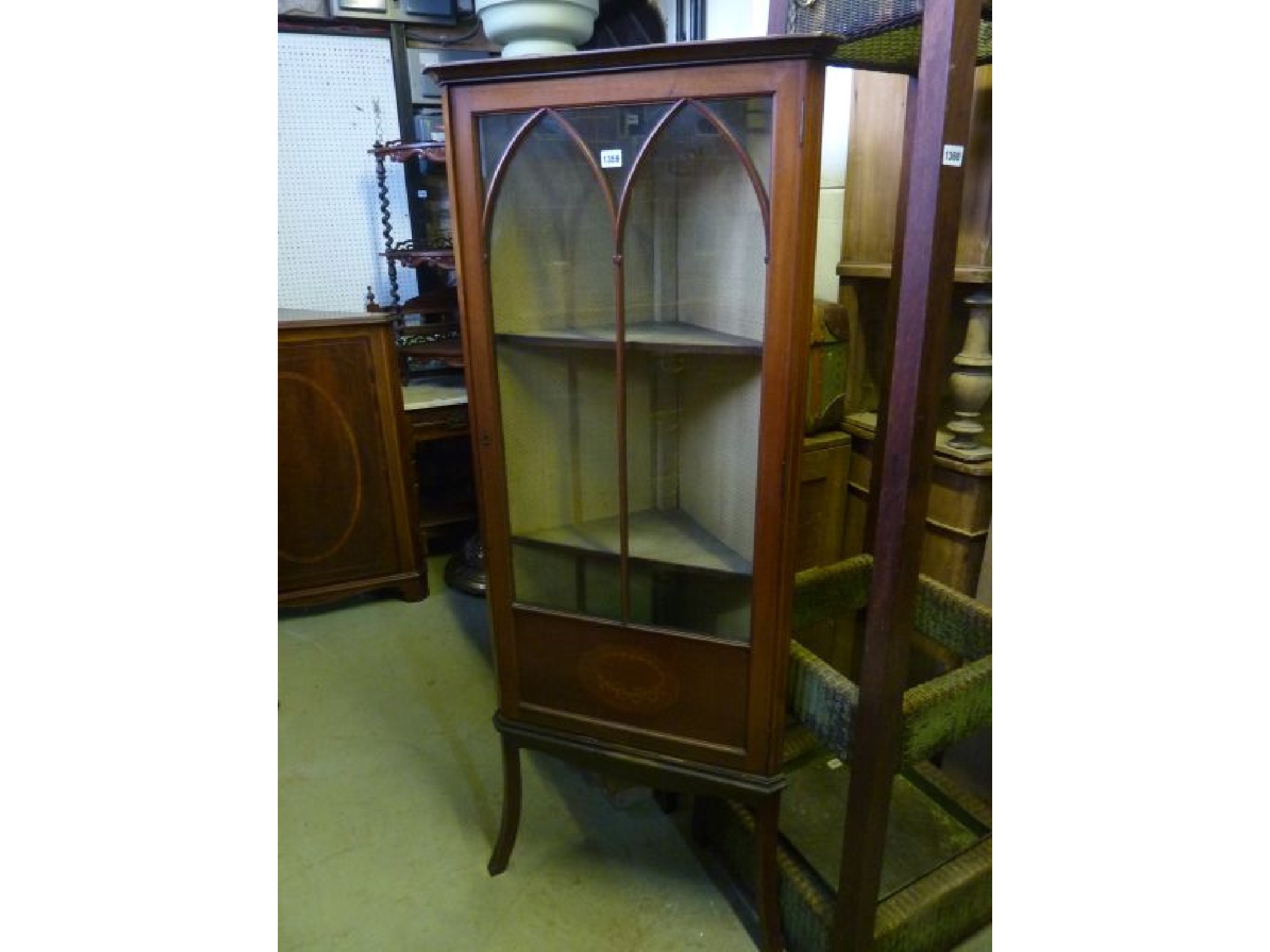 Appraisal: An inlaid Edwardian mahogany freestanding corner display cupboard with three