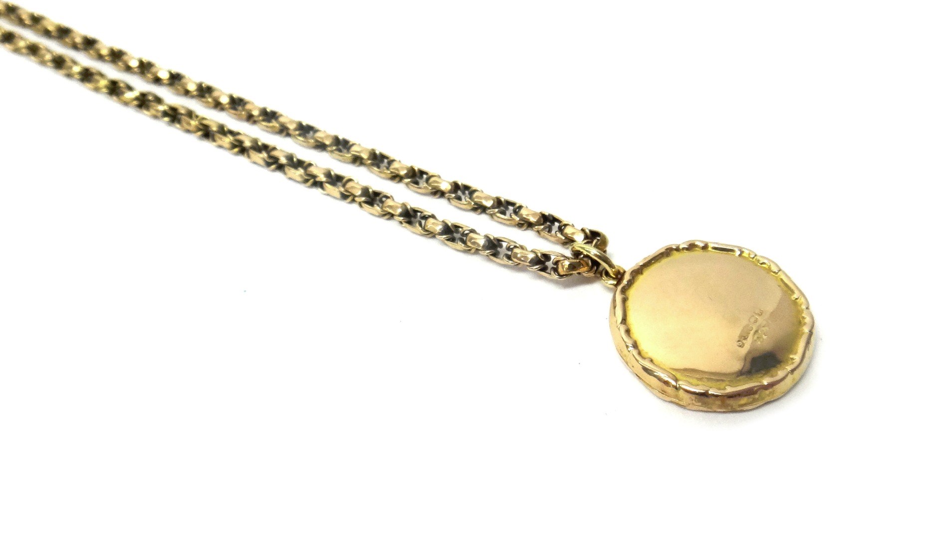 Appraisal: A ct gold circular pendant locket with a scroll decorated