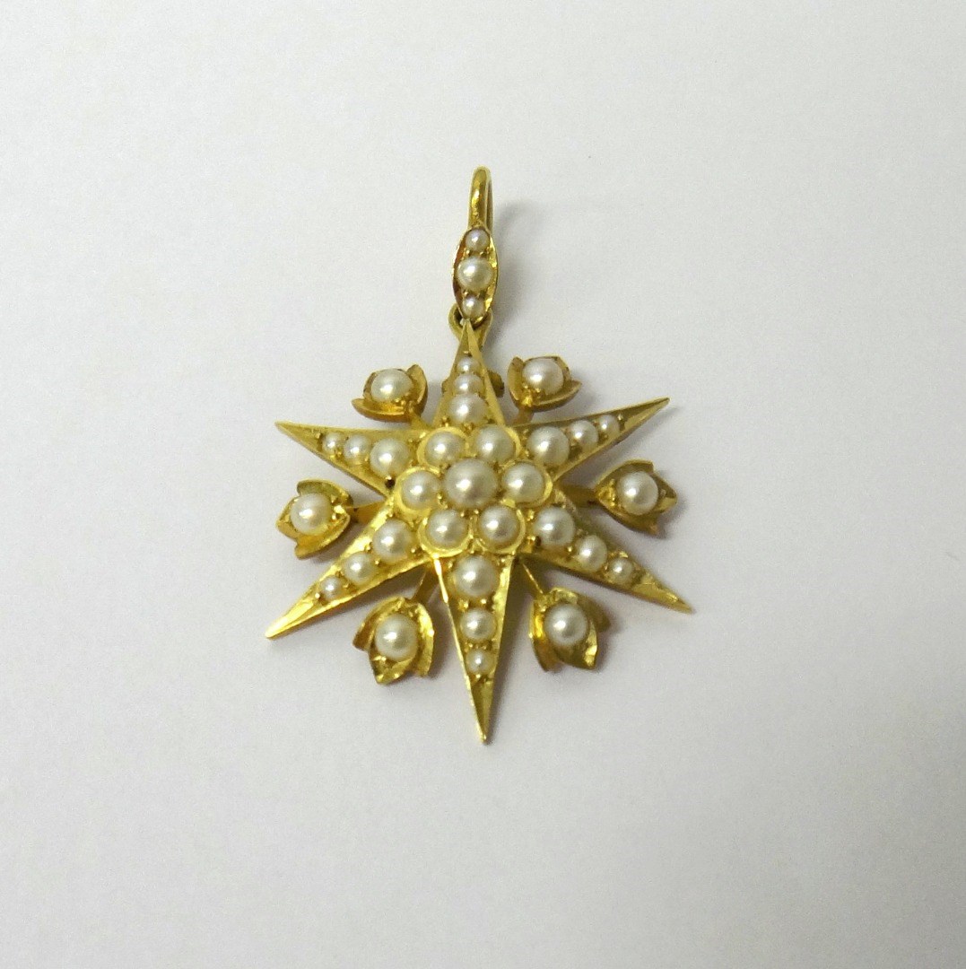 Appraisal: A gold and half pearl set pendant designed as a