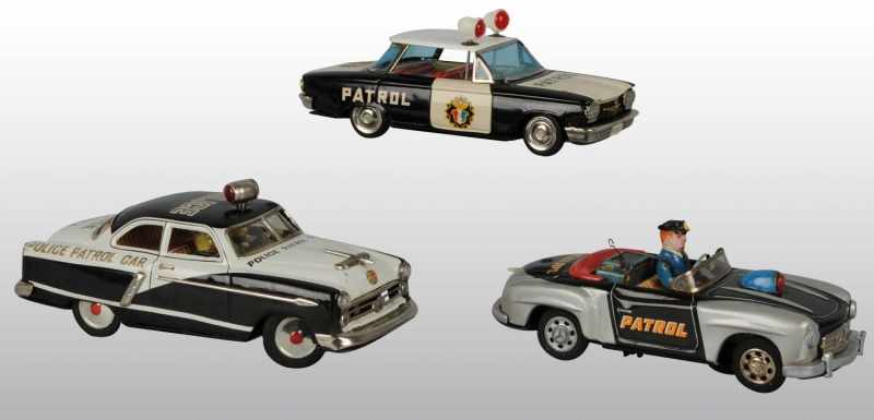 Appraisal: Lot of Tin Police Vehicle Toys Description Japanese Working Includes