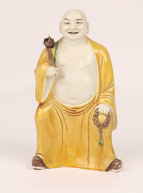 Appraisal: A CHINESE PORCELAIN FIGURE of an Immortal with yellow glazed