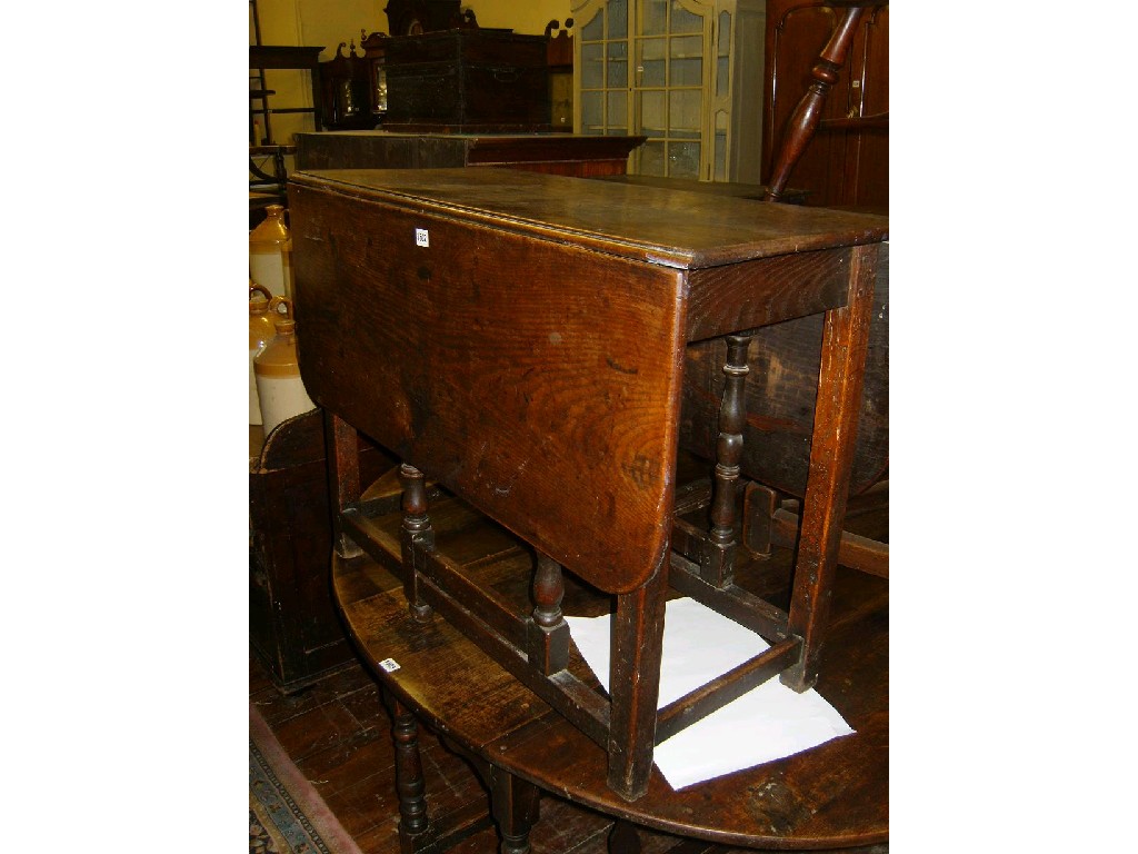 Appraisal: A Georgian oak dropleaf gateleg dining table raised on square