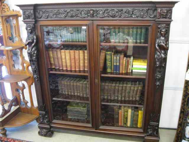 Appraisal: Horner Carved Mahogany Bookcase with faces and elaborate trim ''