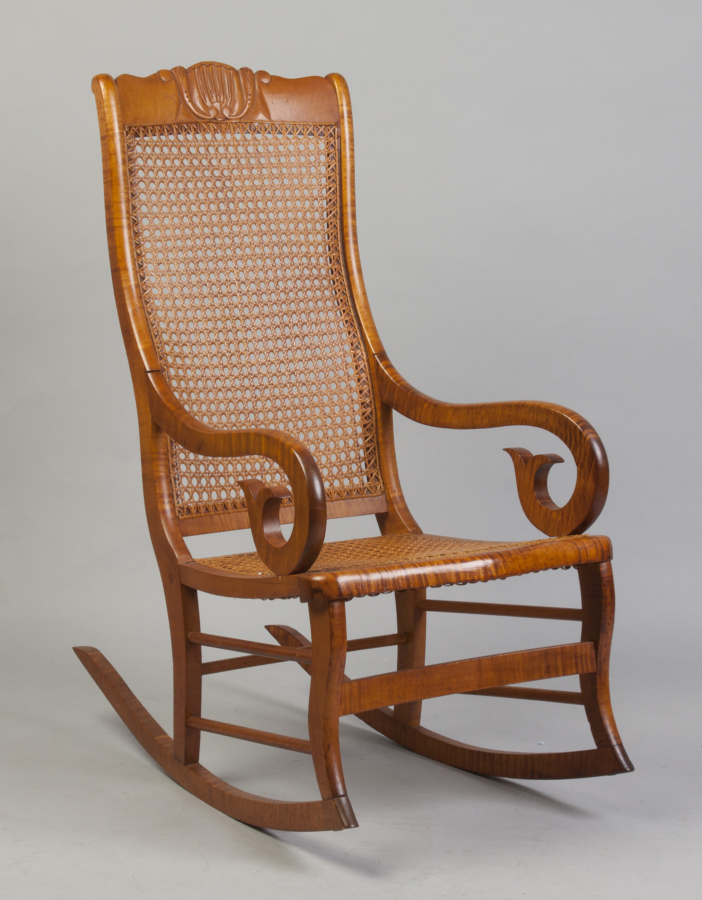 Appraisal: Tiger Maple Rocking Chair Early th cent Stylized floral back