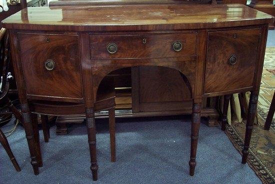 Appraisal: A George IV bowfront sideboard fitted a central drawer and