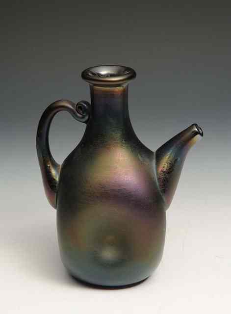 Appraisal: Christopher Dresser for Thomas WebbAn irridescent bronze glass ewer with