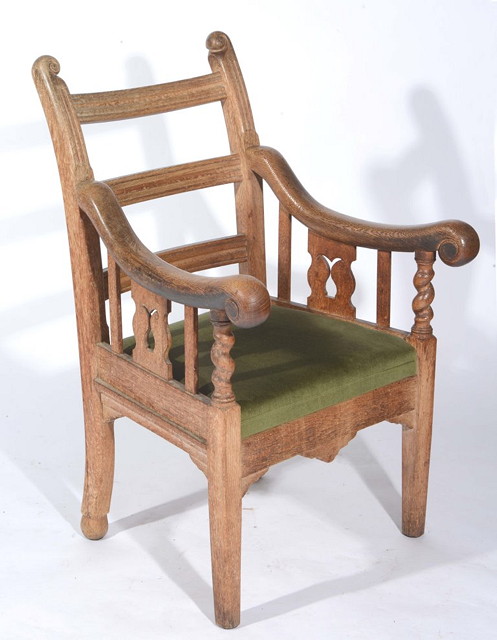 Appraisal: AN EDWARDIAN OAK ARMCHAIR with ladder backs scrolled arms and