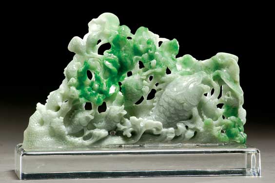 Appraisal: GREEN JADEITE FISH GROUP Well carved Chinese light green jadeite