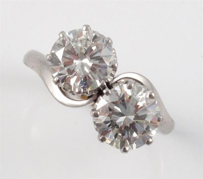 Appraisal: A diamond two stone cross over ring The two round