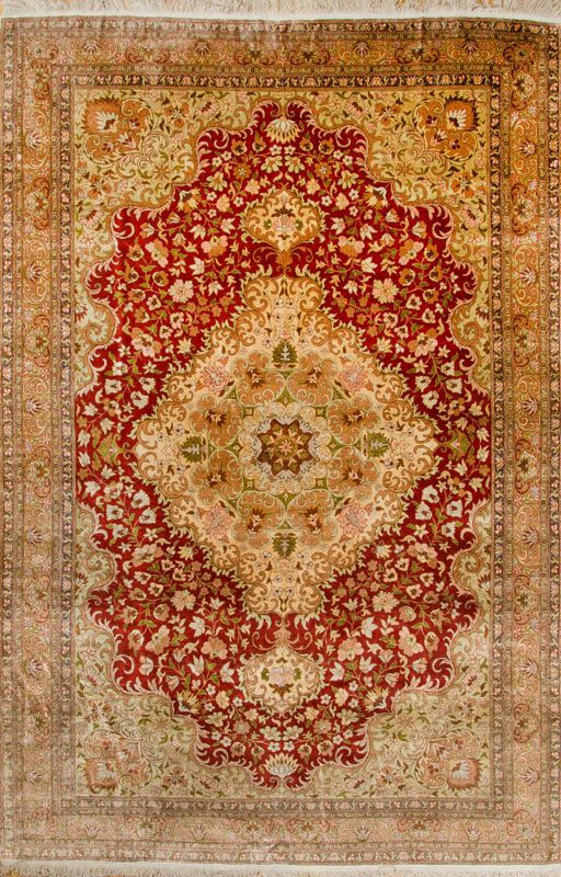 Appraisal: PERSIAN SILK MEDALLION CARPET The tan and pistachio medallion anchored